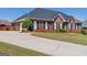 Beautiful brick home with a well-manicured lawn and extended driveway at 130 Gillson Dr, Mcdonough, GA 30253