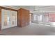 Enclosed sunroom featuring a brick wall, white trim, and a carpeted floor at 130 Gillson Dr, Mcdonough, GA 30253