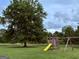 Backyard with a swing set and mature tree at 238 Marks Rd, Mansfield, GA 30055