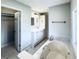Bathroom featuring a bathtub, vanity with cabinets, tile flooring, and natural light from the window at 238 Marks Rd, Mansfield, GA 30055