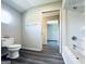 Bright bathroom featuring a white toilet, shower, and modern finishes at 238 Marks Rd, Mansfield, GA 30055