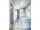 Bathroom featuring a luxurious soaking tub with tile surround and a separate vanity area, enhanced by natural light at 238 Marks Rd, Mansfield, GA 30055