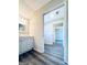 Bathroom featuring hardwood floors, vanity, and open doorway leading to other rooms, creating seamless transitions at 238 Marks Rd, Mansfield, GA 30055