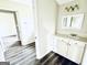 A renovated bathroom with hardwood floors, vanity with countertop, and a decorative vanity light fixture at 238 Marks Rd, Mansfield, GA 30055