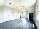 An expansive bonus room featuring hardwood floors, multiple closets, and windows providing ample natural light at 238 Marks Rd, Mansfield, GA 30055