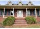 Inviting front porch with brick steps, white columns, and blue shutters on a classic brick home at 238 Marks Rd, Mansfield, GA 30055