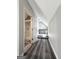 Upstairs hallway with vinyl flooring leading to bathroom and office space at 238 Marks Rd, Mansfield, GA 30055