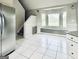 Eat-in kitchen features a bay window, tile flooring, stainless steel refrigerator and stairs to second floor at 238 Marks Rd, Mansfield, GA 30055