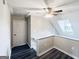 Open landing area with hardwood flooring, ceiling fan, and nearby attic door for storage access at 238 Marks Rd, Mansfield, GA 30055