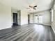Open living room with hardwood floors and neutral color, features ceiling fan, double doors and ample natural light at 238 Marks Rd, Mansfield, GA 30055