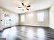 Spacious living room with hardwood floors, neutral paint, ceiling fan and access to outdoor patio through glass doors at 238 Marks Rd, Mansfield, GA 30055