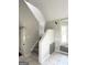 Hallway staircase with tile floors, natural light, and neutral paint at 238 Marks Rd, Mansfield, GA 30055
