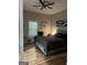 This cozy bedroom features modern ceiling fan, sleek window blinds and contemporary wall art at 690 Mcdonough Se Blvd, Atlanta, GA 30315