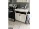 Kitchen view showcasing stainless steel appliances and white cabinets, giving a glimpse of a functional space at 690 Mcdonough Se Blvd, Atlanta, GA 30315