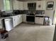 Well-lit kitchen with white cabinets, stainless steel appliances, and gray subway tile backsplash at 690 Mcdonough Se Blvd, Atlanta, GA 30315