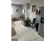 Open-concept living area with modern decor, round table with gray chairs, and stainless steel refrigerator at 690 Mcdonough Se Blvd, Atlanta, GA 30315