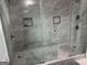 Luxurious shower with dual shower heads, glass doors, and marble-look tiling at 690 Mcdonough Se Blvd, Atlanta, GA 30315