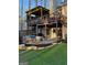 Backyard with wooden pergola, upper deck, stone patio, and putting green at 5930 Shannon Dr, Cumming, GA 30040