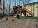 Large backyard with a putting green, upper deck with pergola, and a lower patio at 5930 Shannon Dr, Cumming, GA 30040