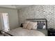 Bedroom featuring exposed brick wall and natural light from an adjacent bathroom at 5930 Shannon Dr, Cumming, GA 30040