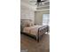Bedroom features a modern ceiling fan and an accent wall of painted exposed brick at 5930 Shannon Dr, Cumming, GA 30040