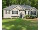 Well-maintained single-story home with a manicured lawn and a welcoming front door at 5930 Shannon Dr, Cumming, GA 30040