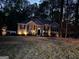 Charming single-story home with well-lit exterior and manicured lawn, creating a welcoming curb appeal at 5930 Shannon Dr, Cumming, GA 30040