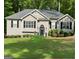 Well-maintained single-story home with black shutters, green lawn, and manicured landscaping enhancing curb appeal at 5930 Shannon Dr, Cumming, GA 30040