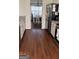 Eat-in kitchen with dark hardwood floors, light cabinets, and a view into dining area at 5930 Shannon Dr, Cumming, GA 30040