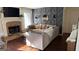 Comfortable living room with a stone fireplace, unique accent wall, and ample seating at 5930 Shannon Dr, Cumming, GA 30040