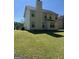 Two story home showing the backyard with a lawn and patio at 5041 Cottage Grove Pl, Union City, GA 30291