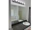 Bright bathroom with a large mirror, a white sink, and a combination shower and tub at 5041 Cottage Grove Pl, Union City, GA 30291