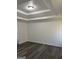 Spacious bedroom featuring modern gray wood floors, white walls, and recessed ceilings at 5041 Cottage Grove Pl, Union City, GA 30291