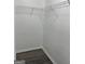 Walk-in closet with white shelving, neutral walls, and wood-look floors at 5041 Cottage Grove Pl, Union City, GA 30291