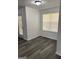 Bright dining area with large window, modern flooring, and chair rail at 5041 Cottage Grove Pl, Union City, GA 30291