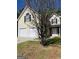 Charming two-story home with an attached two-car garage and a well-maintained lawn at 5041 Cottage Grove Pl, Union City, GA 30291