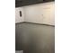 Attached garage space showcasing gray sealed concrete floors and a white door at 5041 Cottage Grove Pl, Union City, GA 30291