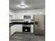 Modern kitchen featuring stainless steel appliances, white cabinets, and sleek countertops at 5041 Cottage Grove Pl, Union City, GA 30291