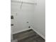 Convenient laundry room featuring durable flooring, overhead shelving, and utility connections at 5041 Cottage Grove Pl, Union City, GA 30291