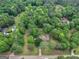 Aerial view of a wooded property featuring a home and pool surrounded by mature trees at 1710 Crumbley Rd, Mcdonough, GA 30252