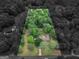 Aerial view of a wooded property with mature trees and a single-story home at 1710 Crumbley Rd, Mcdonough, GA 30252