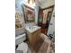 Full bathroom boasts a vanity, a sink, a toilet, and a framed mirror at 1710 Crumbley Rd, Mcdonough, GA 30252