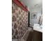Full bathroom with patterned shower curtain, patterned towels, and a sink with marble countertop at 1710 Crumbley Rd, Mcdonough, GA 30252