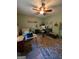 Cozy bedroom is staged as an office with a ceiling fan, desk, and sitting chair at 1710 Crumbley Rd, Mcdonough, GA 30252