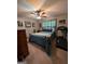 Bedroom with a ceiling fan, a bed with a blue comforter, and a treadmill at 1710 Crumbley Rd, Mcdonough, GA 30252