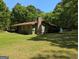Charming single-story home with a brick chimney and a well-maintained lawn at 1710 Crumbley Rd, Mcdonough, GA 30252