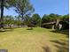Spacious front yard with mature trees and a single-story home with a brick chimney at 1710 Crumbley Rd, Mcdonough, GA 30252