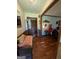 Hallway with wood floors and trim, and a cushioned bench at 1710 Crumbley Rd, Mcdonough, GA 30252