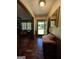 Hallway with hardwood floors, decorative wallpaper, and a cushioned bench for seating at 1710 Crumbley Rd, Mcdonough, GA 30252