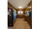 Galley kitchen with wood cabinets, stainless steel appliances, and tile flooring at 1710 Crumbley Rd, Mcdonough, GA 30252